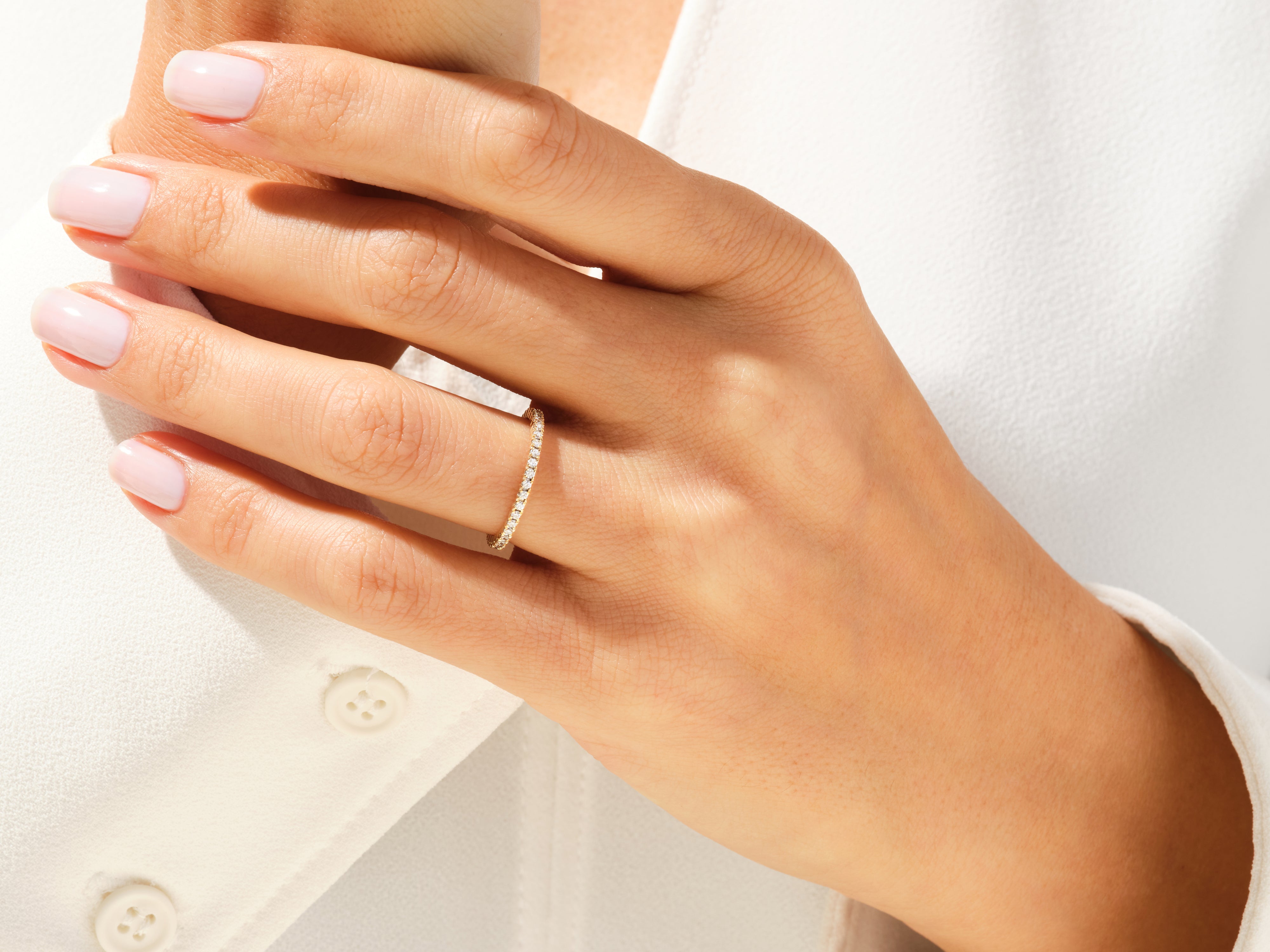 Diamond band ring on a woman's hand, jewelry photography