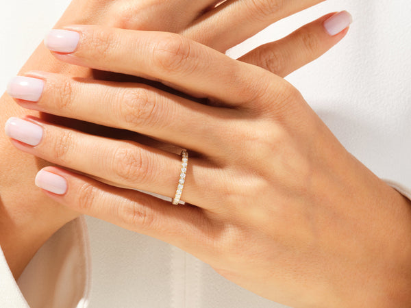 Diamond eternity band on a woman's hand, jewelry firm product