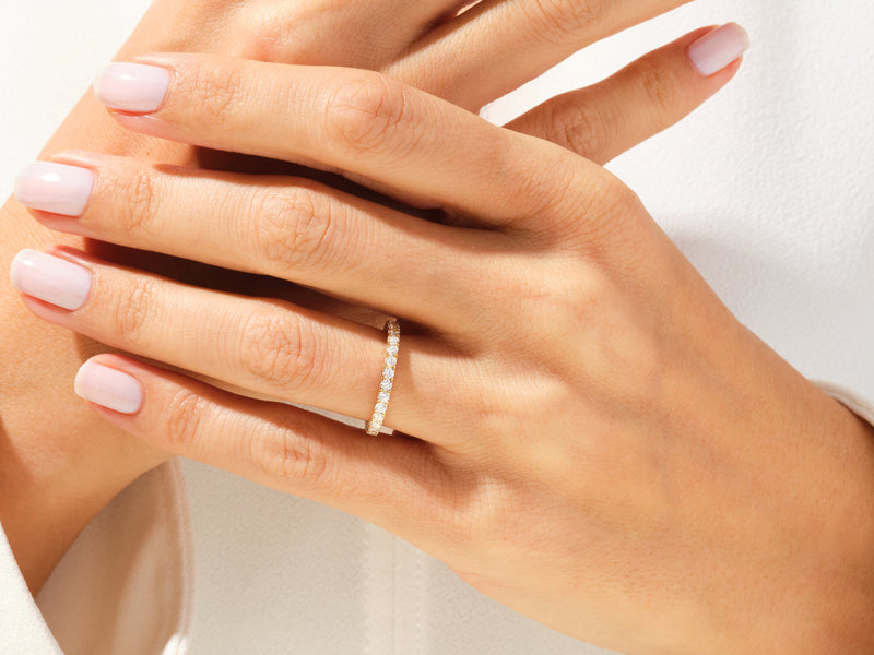 Diamond eternity band on a woman's hand, jewelry firm product