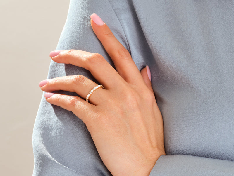 Diamond eternity ring on a woman's hand, jewelry product photography