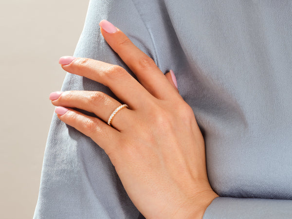 Diamond eternity ring on a woman's hand, jewelry product photography