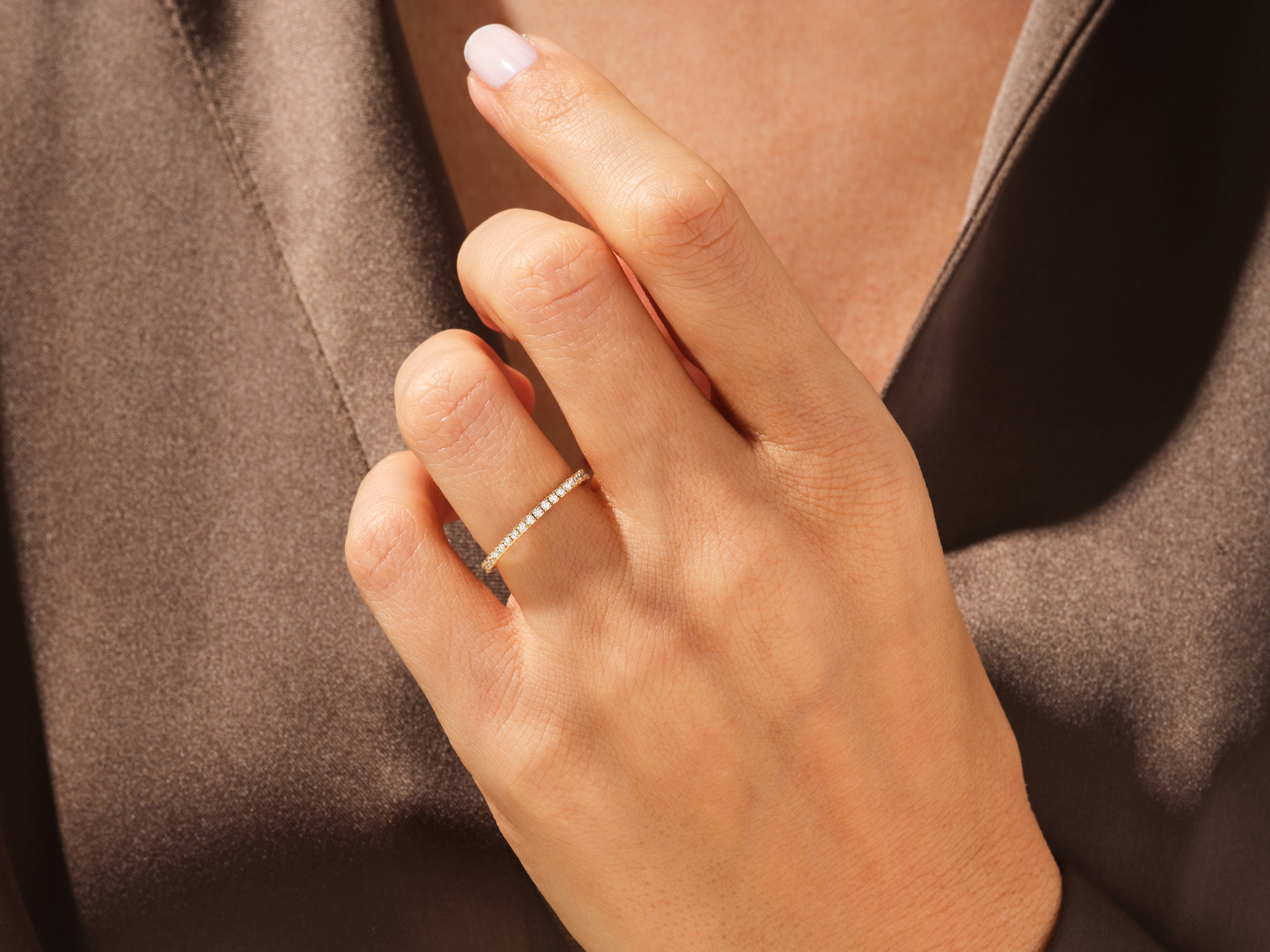 Diamond eternity band on a hand, fine jewelry for women