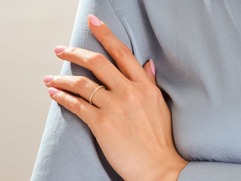 Diamond eternity ring on a woman's hand, jewelry product photography