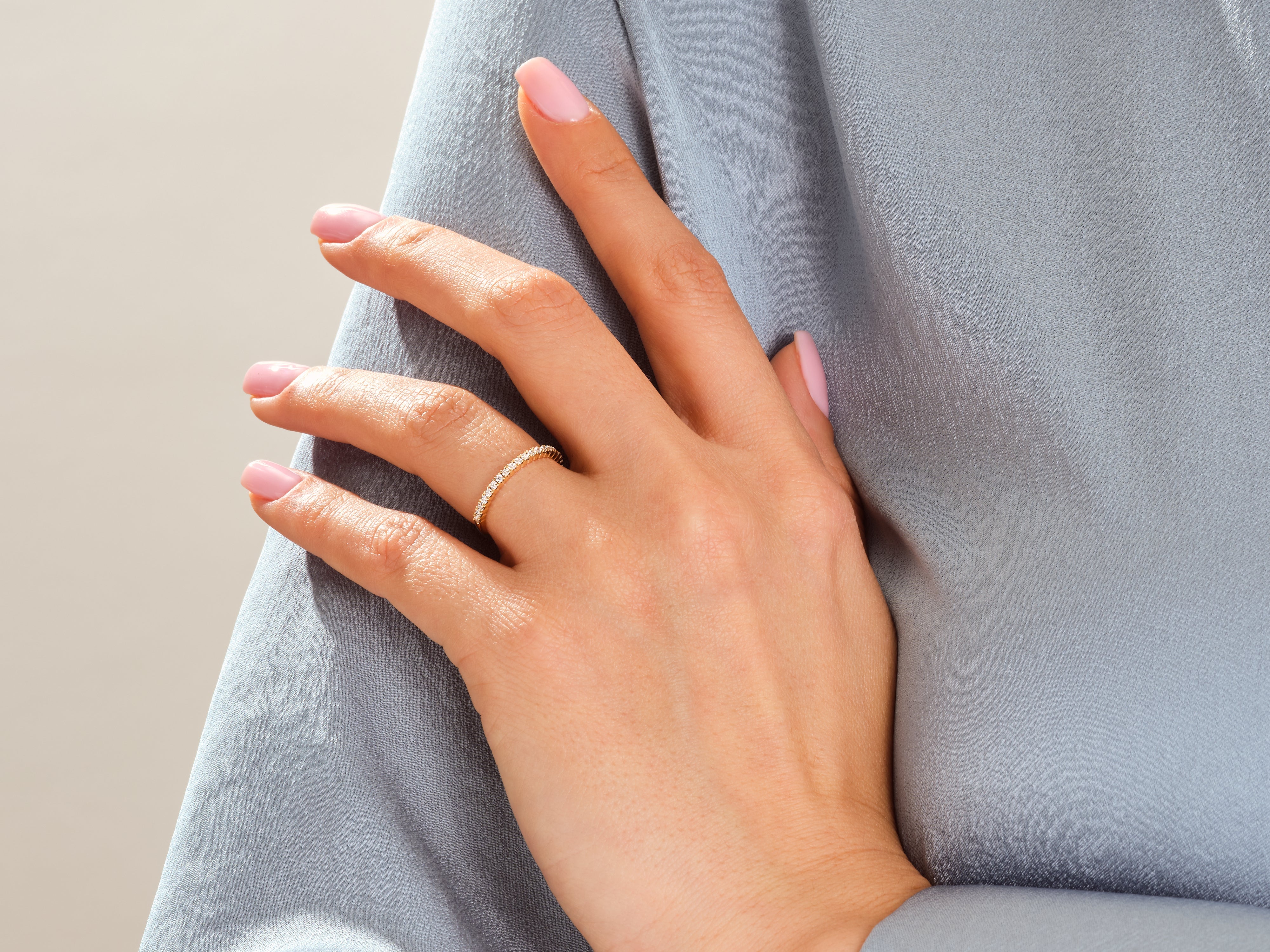 Diamond band ring on a woman's hand, jewelry product photography
