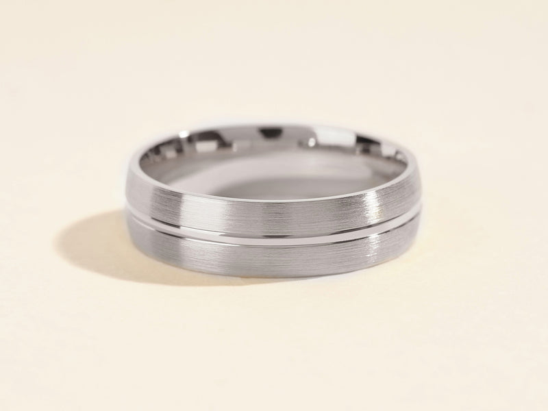 Brushed silver wedding band with polished groove detail