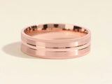 Rose gold ring with textured band and polished center groove