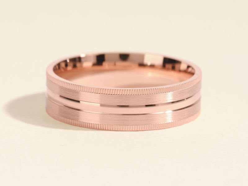 Rose gold ring with textured band and polished center groove