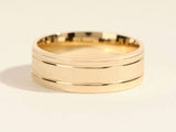 Gold wedding band with brushed finish and polished edges
