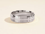 Men's brushed silver wedding band with geometric design