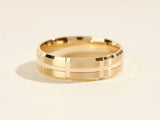 Gold ring with brushed finish and geometric pattern
