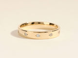 Gold band ring with scattered diamonds, fine jewelry