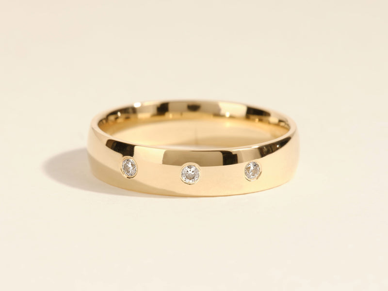 Gold wedding band with three diamonds, fine jewelry