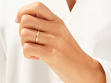 Diamond studded gold ring on a woman's finger