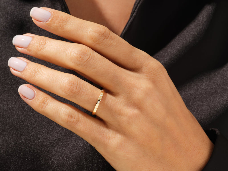 Gold diamond band ring on a woman's finger