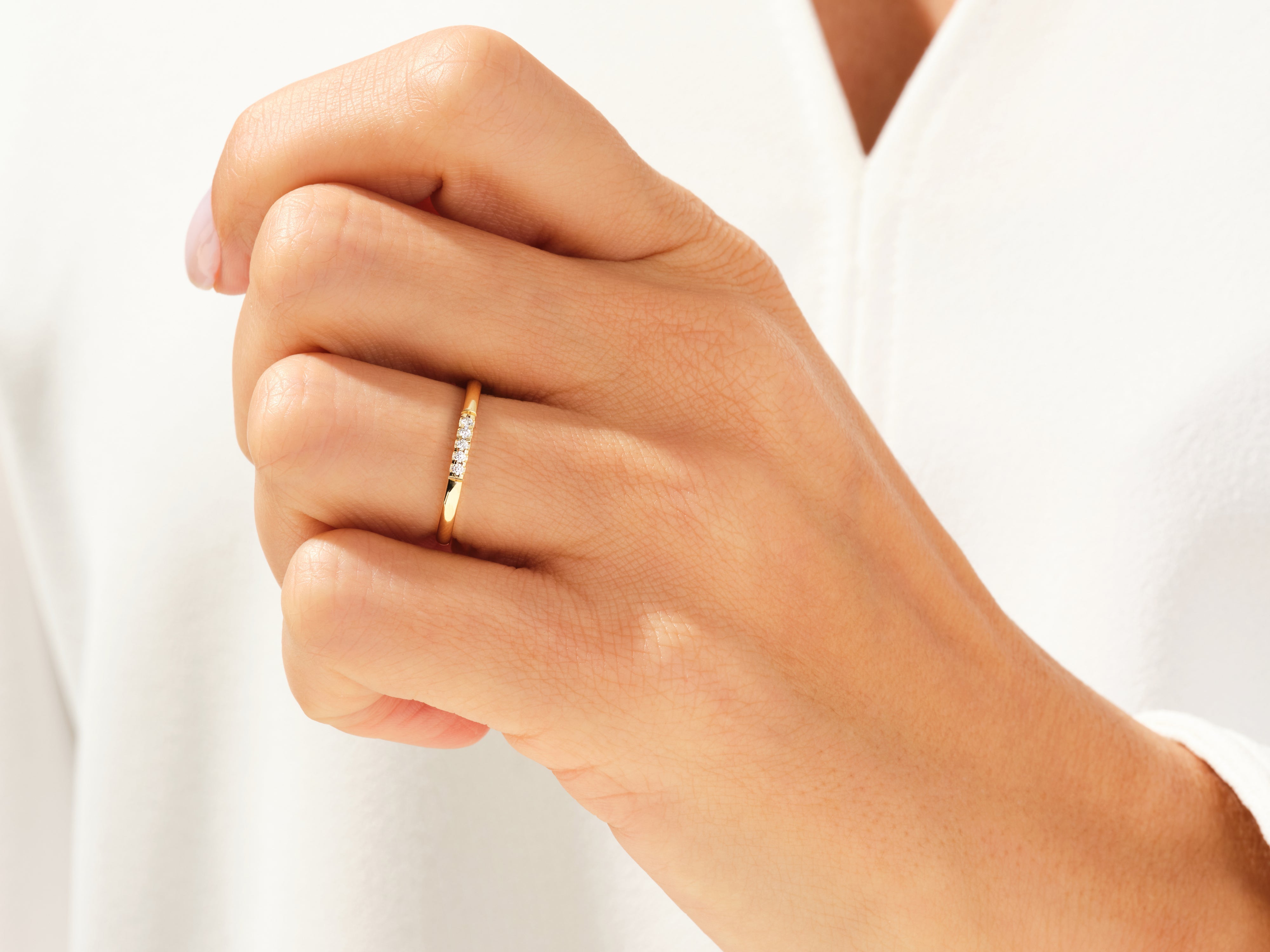 Gold diamond band ring on a woman's finger