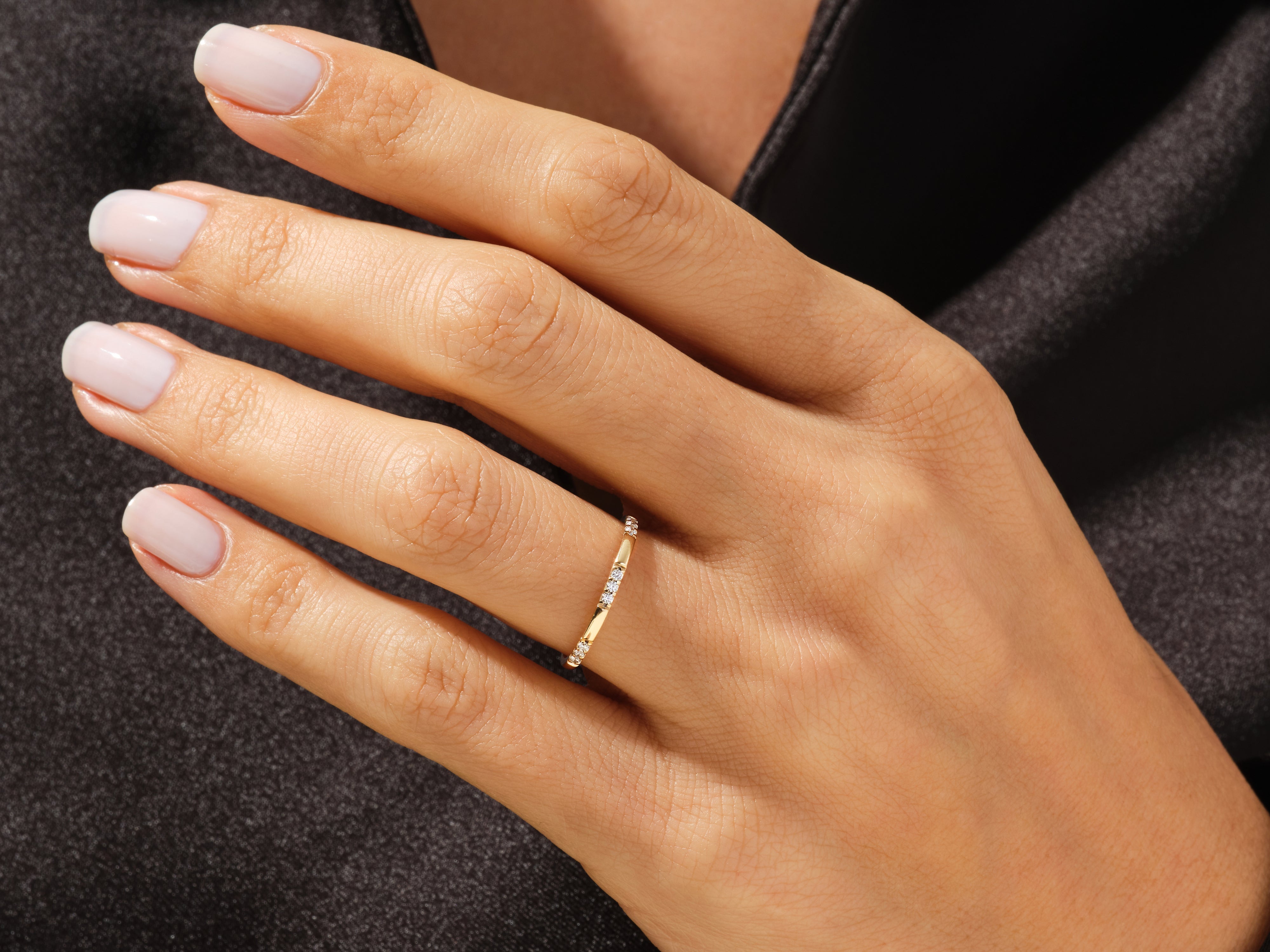 Delicate diamond band ring on a woman's hand