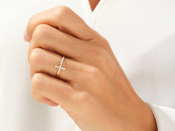 Diamond cross ring on a woman's finger, fine jewelry