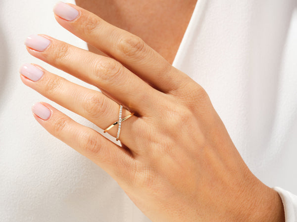 Diamond criss-cross ring on a woman's hand, fine jewelry