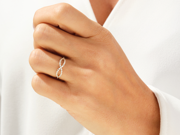 Diamond infinity ring on a woman's hand