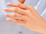 Gold diamond bypass ring on a woman's hand