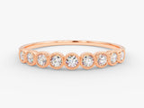 Rose gold diamond band ring with bezel-set stones