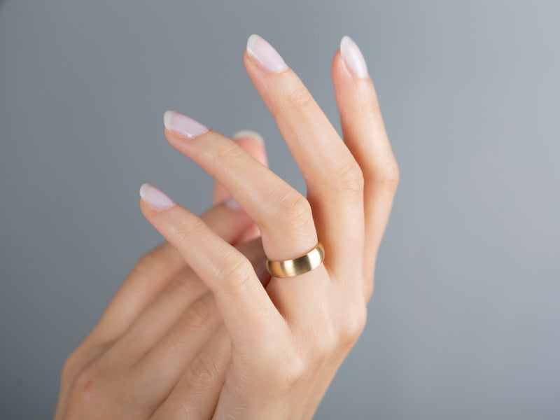 Elegant gold ring on a woman's hand, jewelry photography
