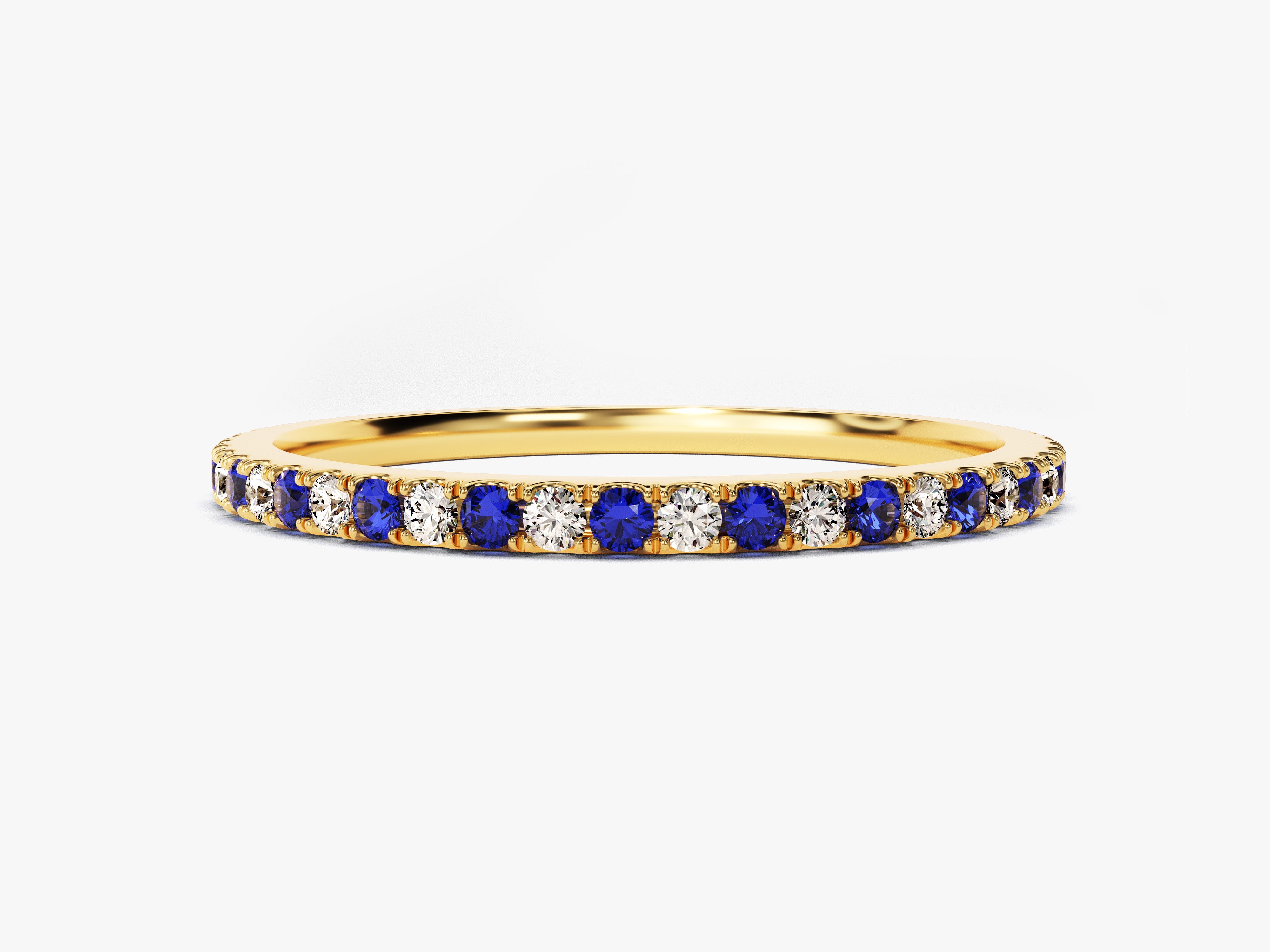 Gold band ring with alternating blue sapphires and diamonds