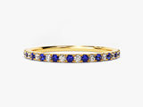 Gold band ring with alternating blue sapphires and diamonds