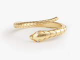Gold snake ring with diamond eyes, fine jewelry design
