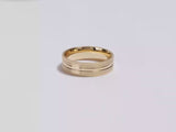 A video showing a yellow gold 6mm mid-beveled and matte milgrain men's gold wedding band spinning on a white background