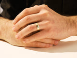 Gold wedding band on man's hand, elegant jewelry for him