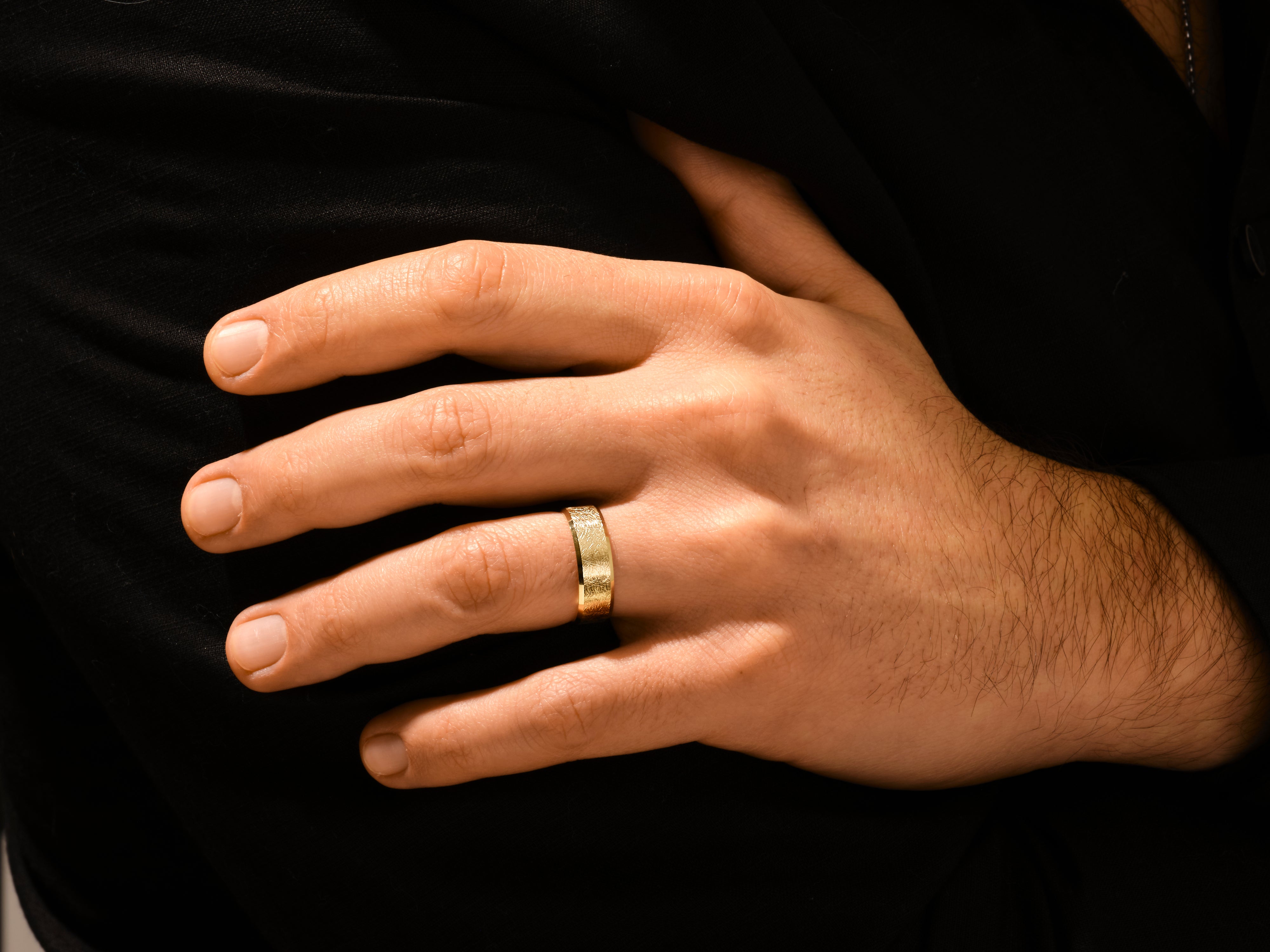Men's textured gold ring on hand, luxury jewelry