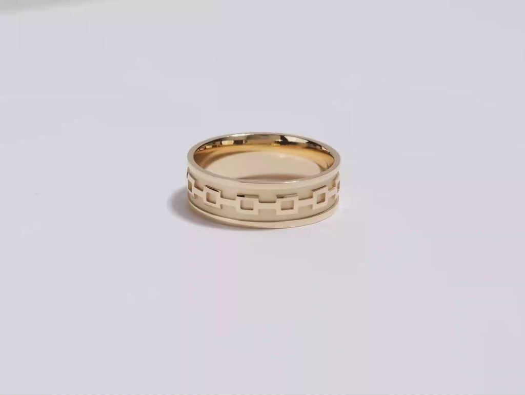 A video showing a yellow gold 7mm celtic pattern mMen's wedding band spinning on a white background