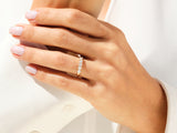 Gold diamond band ring on a woman's finger, jewelry
