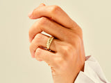 Gold twisted ring on a hand, fine jewelry