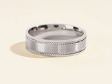 Men's brushed platinum wedding band with textured detail