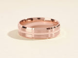 Rose gold ring with brushed finish and geometric pattern