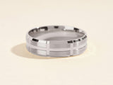Men's brushed silver wedding band with geometric design