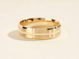 Gold ring with brushed finish and geometric pattern