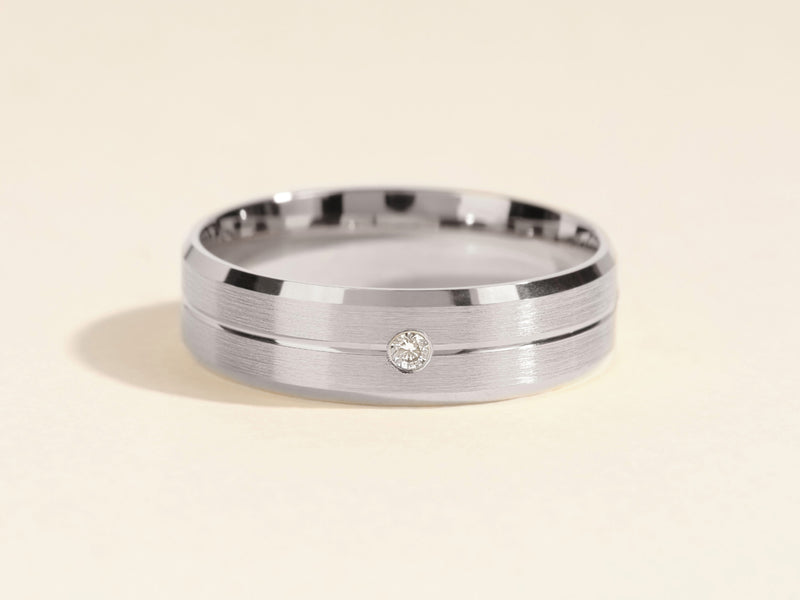 Men's brushed silver ring with a single diamond accent