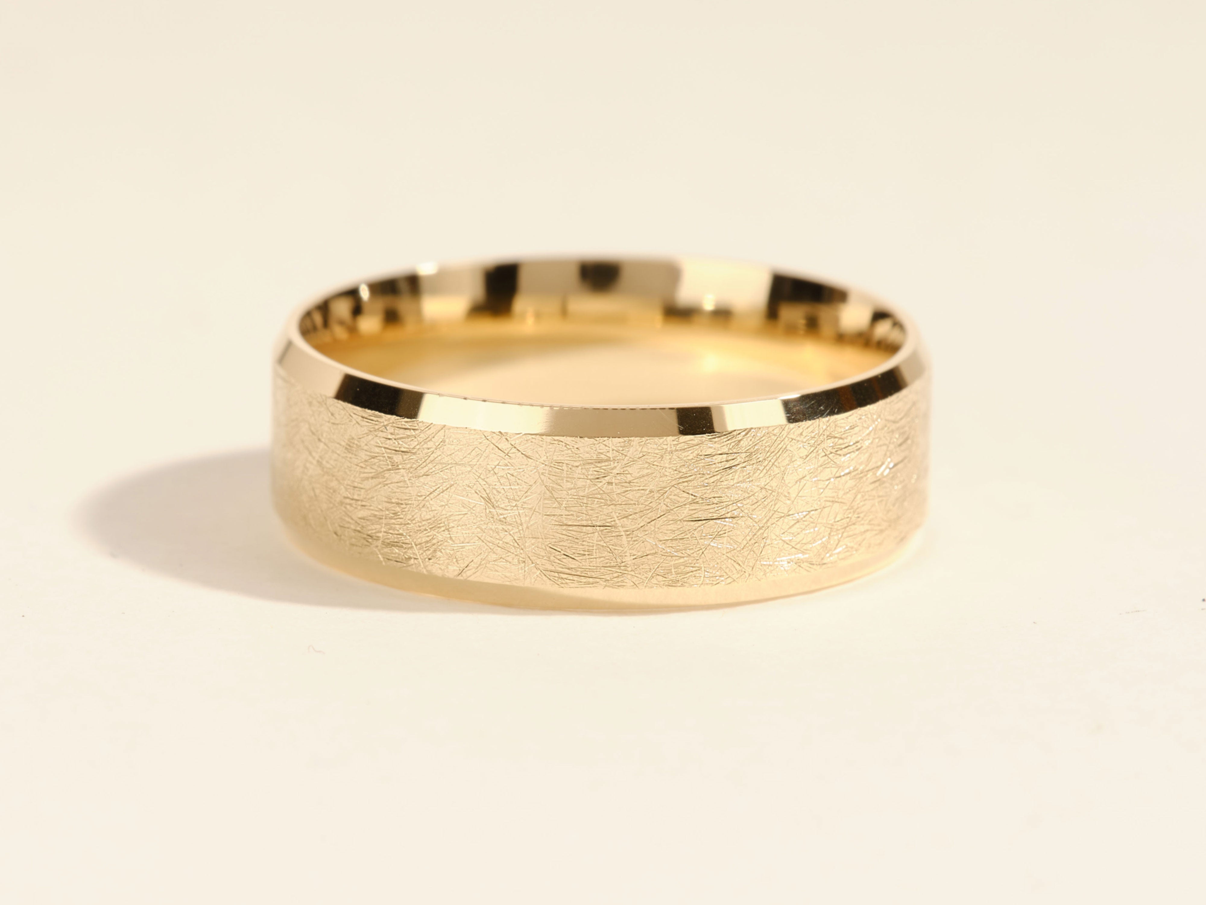 Textured gold wedding band from jewelry company