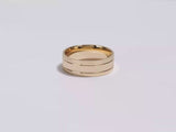 a video showing a yellow gold 7mm double-grooved men's gold wedding band spinning on a white background.